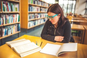 Young Caucasian Woman Studying in Public Library