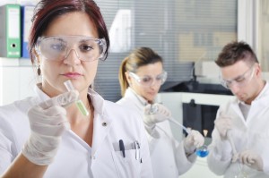 Attractive young PhD students scientists observing in the laboratory