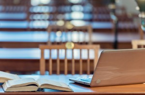 Books and laptop on a wooden table