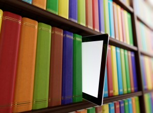 Side view of library with books and a tablet sticking out