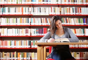 Portrait of a student  girl studying at library
